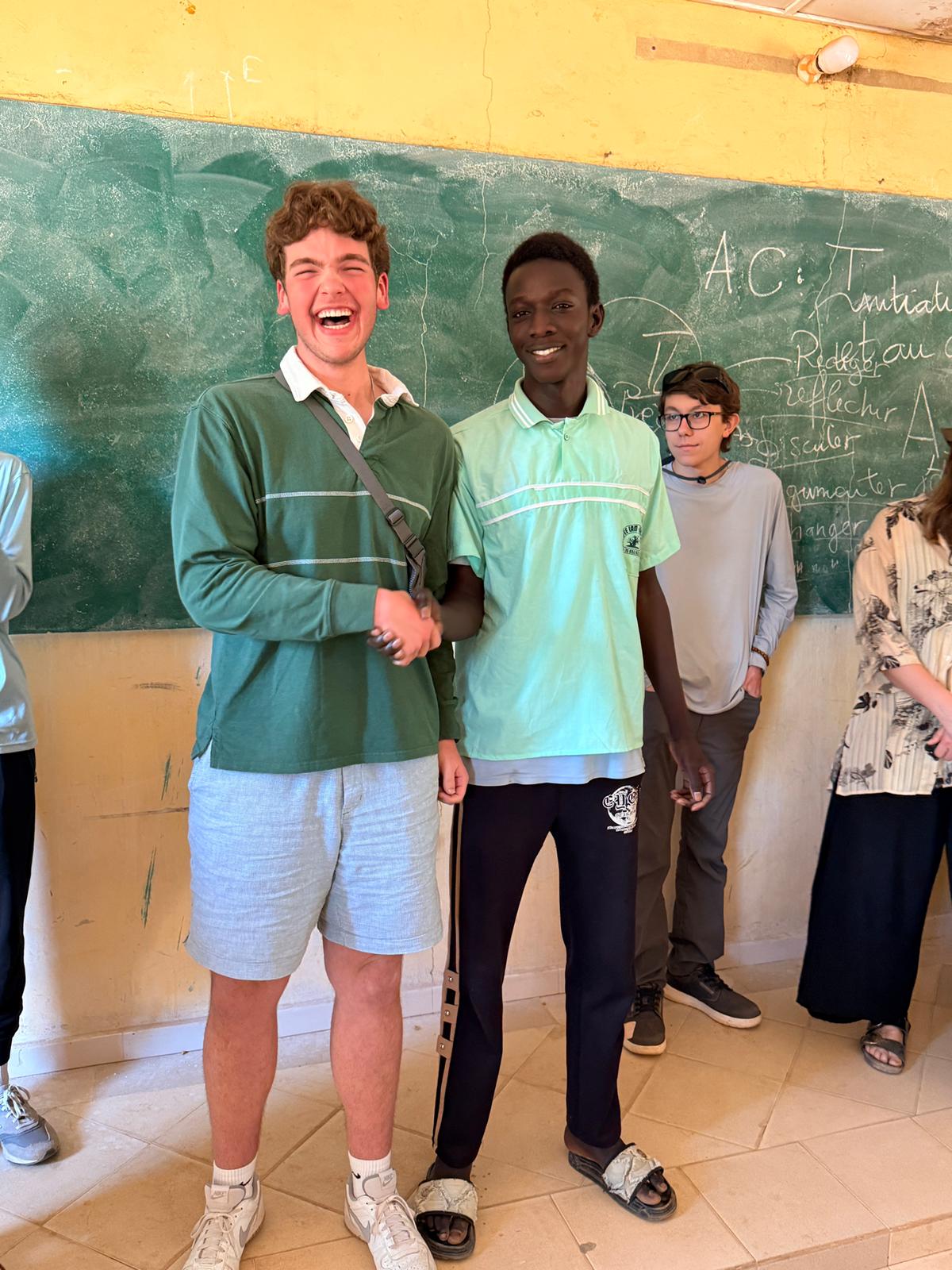 Students connecting with Senegalese peers during a classroom visit in Senegal