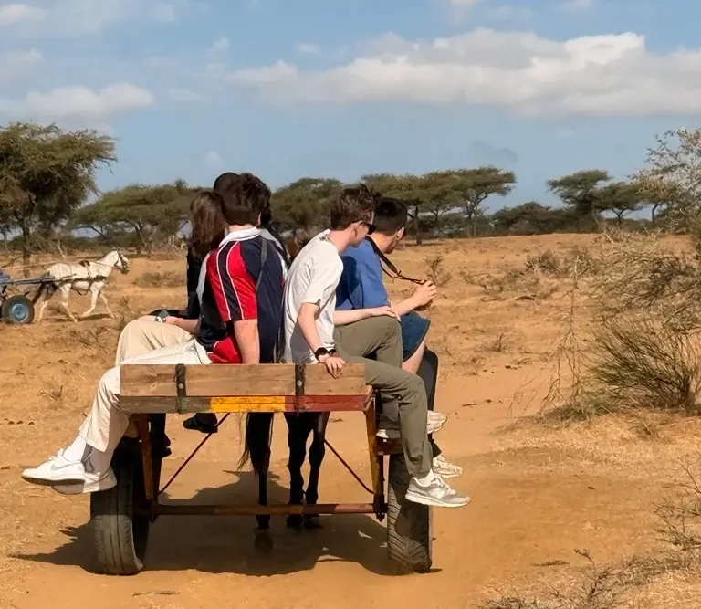 Student group traveling by donkey cart through the Senegalese countryside
