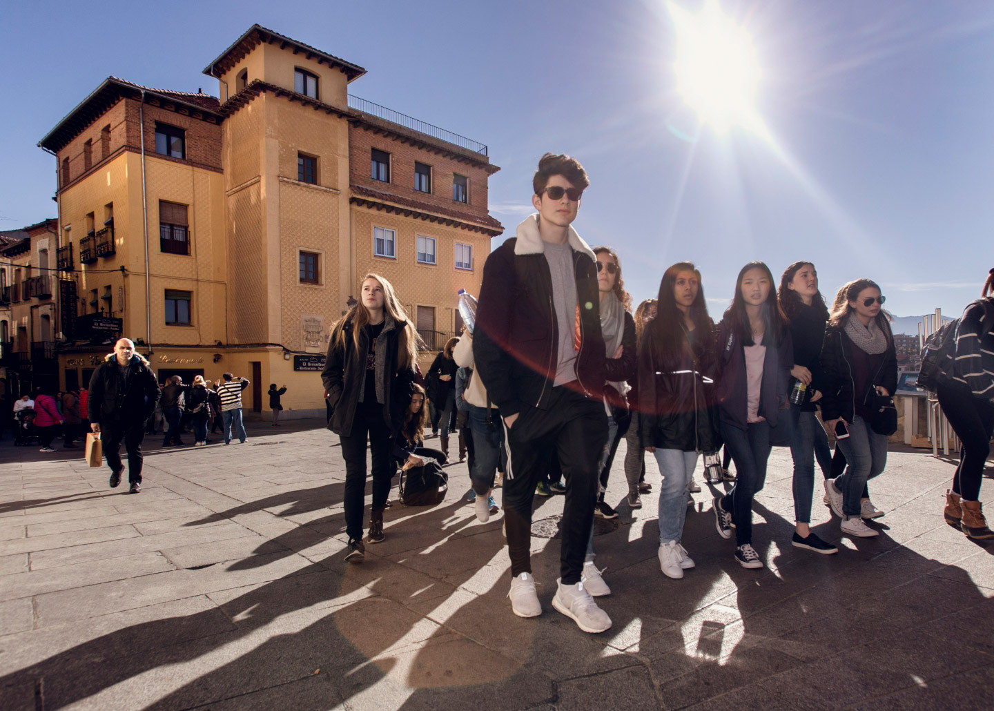 group of students walking together underneath the sun